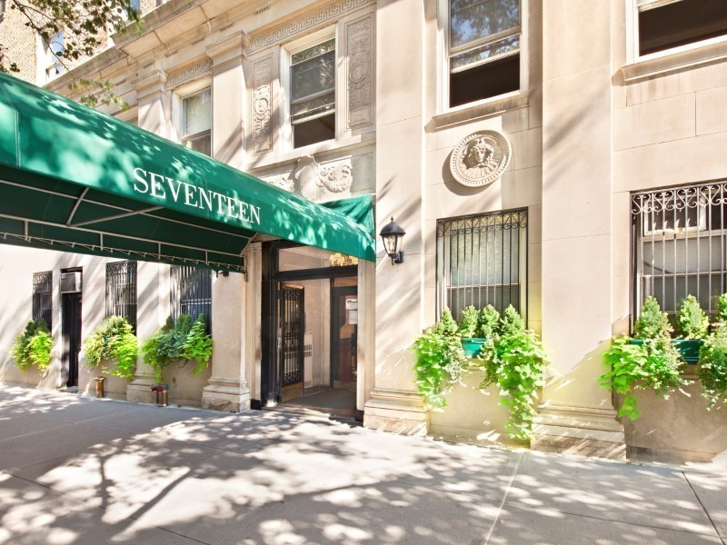 Office building on busy urban street with plants
